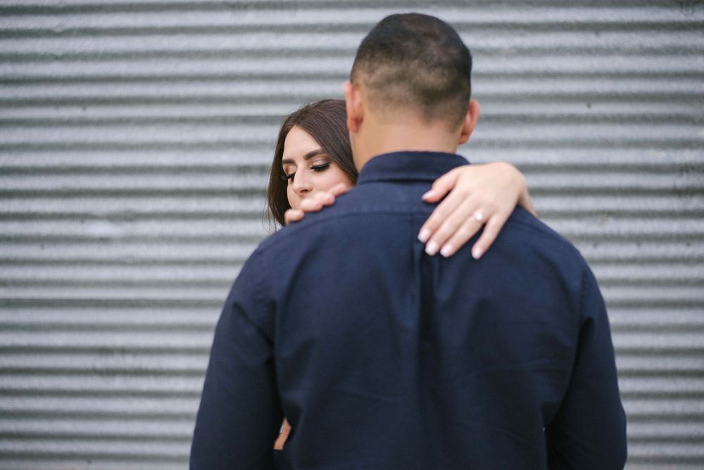 couple hugging each other. engagement ring. Old Hidalgo Pump House. Hidalgo, Texas. Wedding photographer