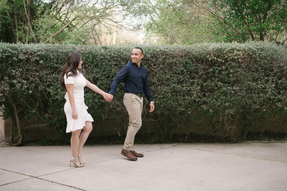 couple walking by a bush. Old Hidalgo Pump House. Hidalgo, Texas. Wedding photographer