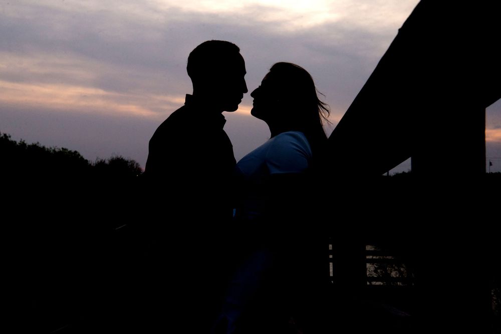 backlights of a couple. skies. kissing. Old Hidalgo Pump House. Hidalgo, Texas. Wedding photographer