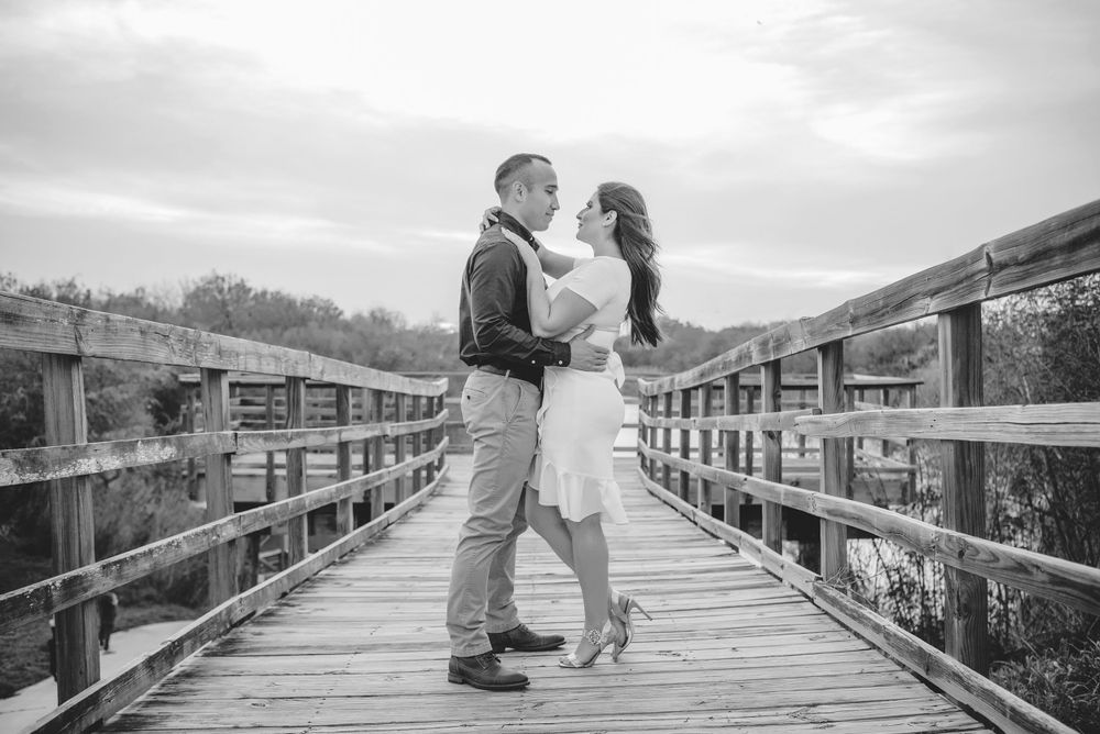 couple standing on a bridge. black and white Old Hidalgo Pump House. Hidalgo, Texas. Wedding photographer