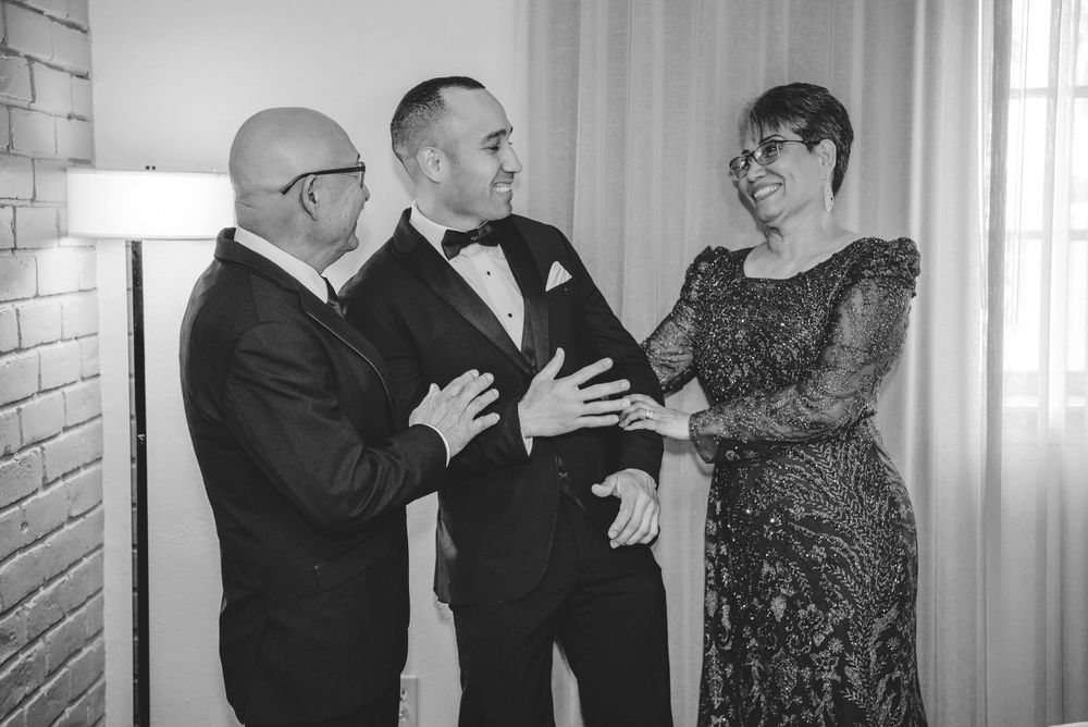 parents laughing with groom. Casa De Palmas, Trademark Collection by Wyndham. Wedding photographer