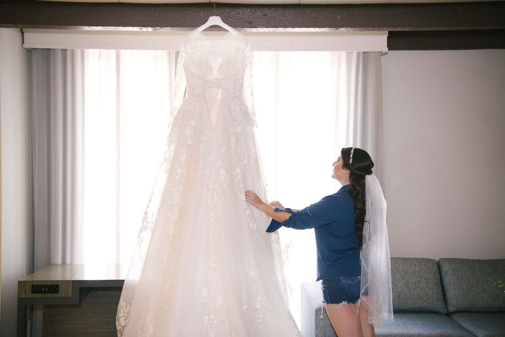bride looking up at her dress. Casa De Palmas, Trademark Collection by Wyndham. Wedding photographer