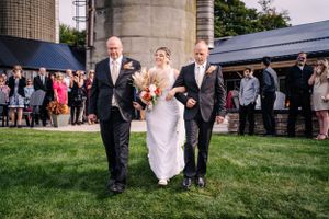 A wedding processional on church grounds with formal attire and traditional styling.