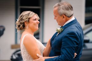 Joyful wedding moment shared between couple during outdoor first look.