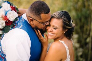 Tender moment shared between newlyweds during outdoor portrait session.