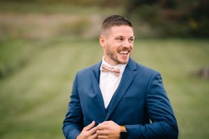 A joyful expression captured during wedding preparations outdoors.