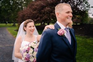 A happy couple shares a candid moment during their outdoor wedding photos.