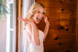 An emotional wedding day moment captured in a rustic wood-paneled room.