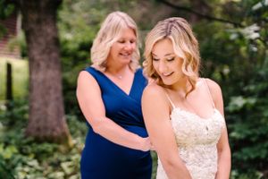 A touching wedding moment photographed in a garden setting.