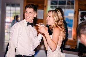 A couple laughs and dances together during their wedding reception.