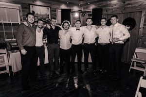 A group photo of formally dressed guests at an indoor venue.
