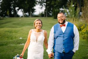 Happy couple laughing together during outdoor wedding portraits.