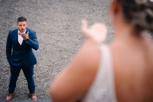 Candid wedding moment captured between couple during outdoor portrait session.