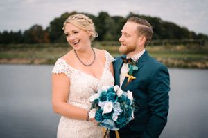 Couple shares authentic laughter during waterfront wedding photography session.