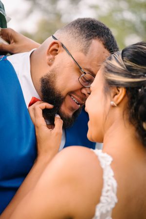 Close-up of couple sharing joyful laughter during wedding portraits.