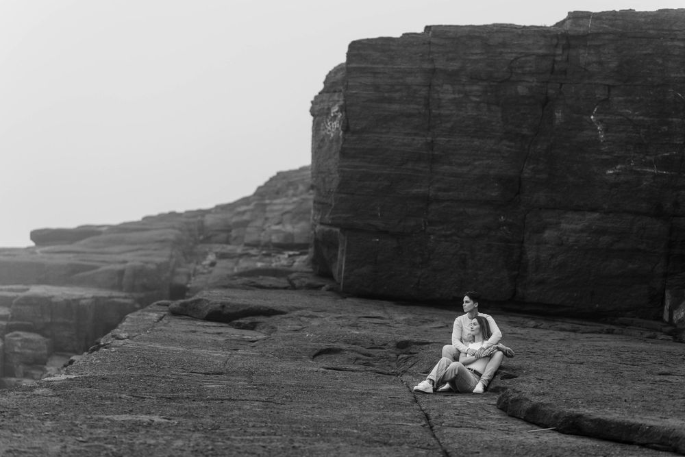 Dramatic coastal cliffs and rock formations against an overcast sky.