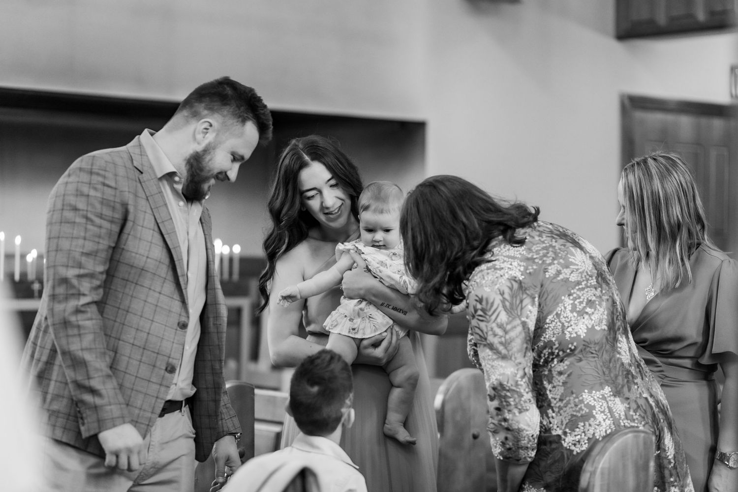 Group of people share joyful moment during baptism ceremony in church.
