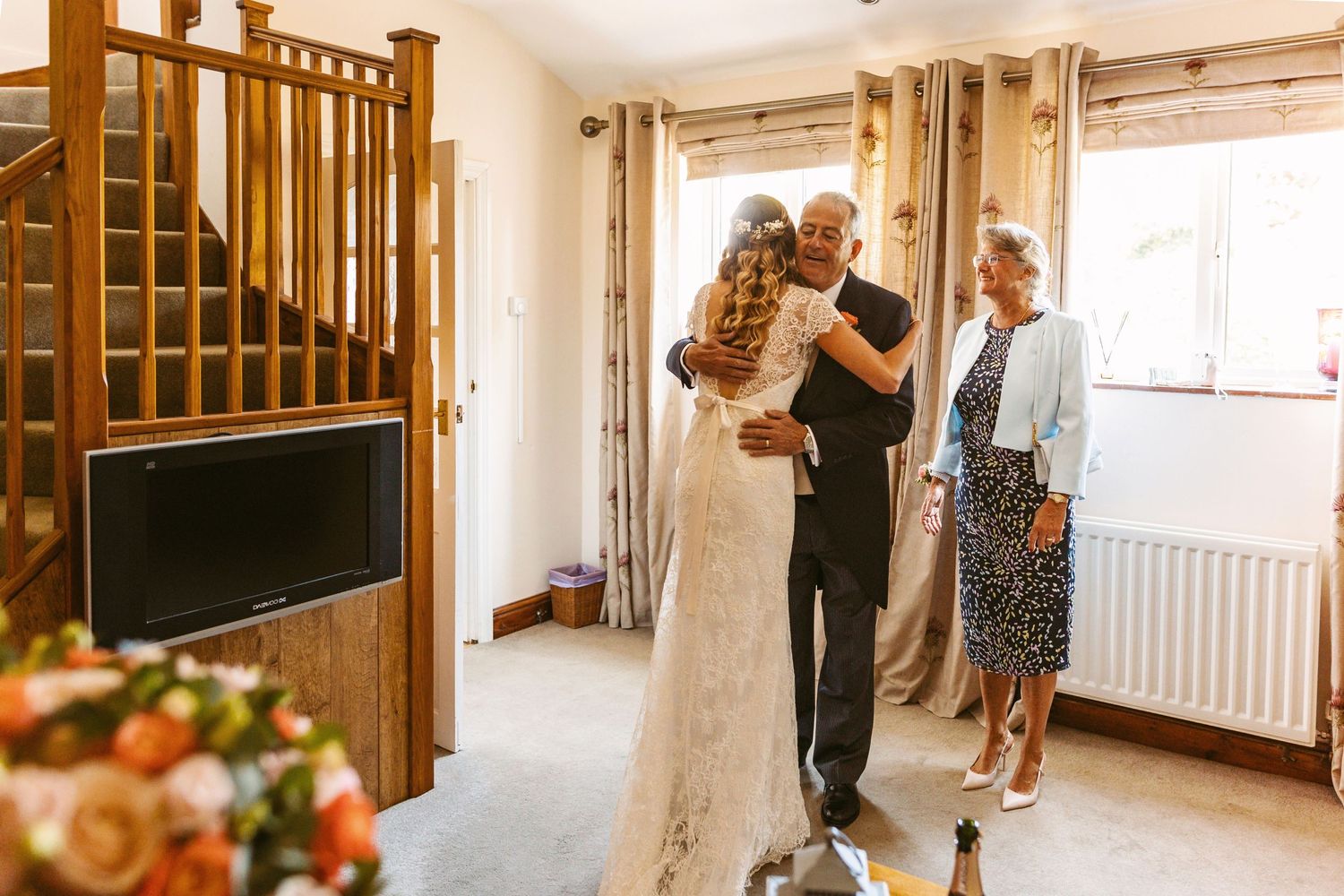 Wedding preparations taking place in a cozy home interior with wooden furniture.