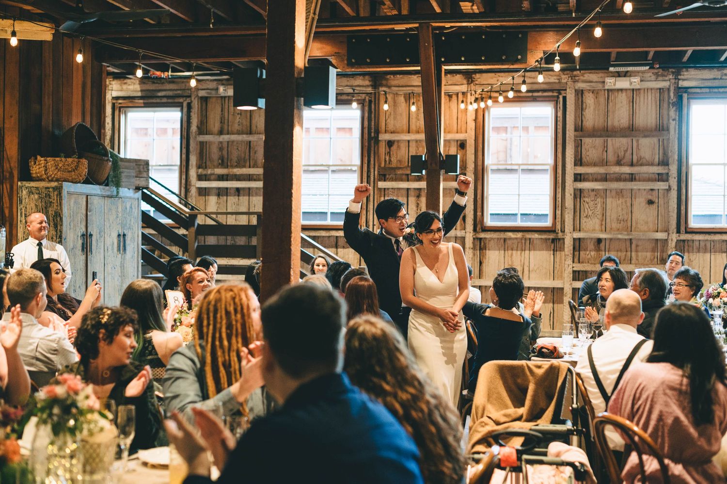 bride and groom making their grand entrance in the barn at cooper molera in Monterey