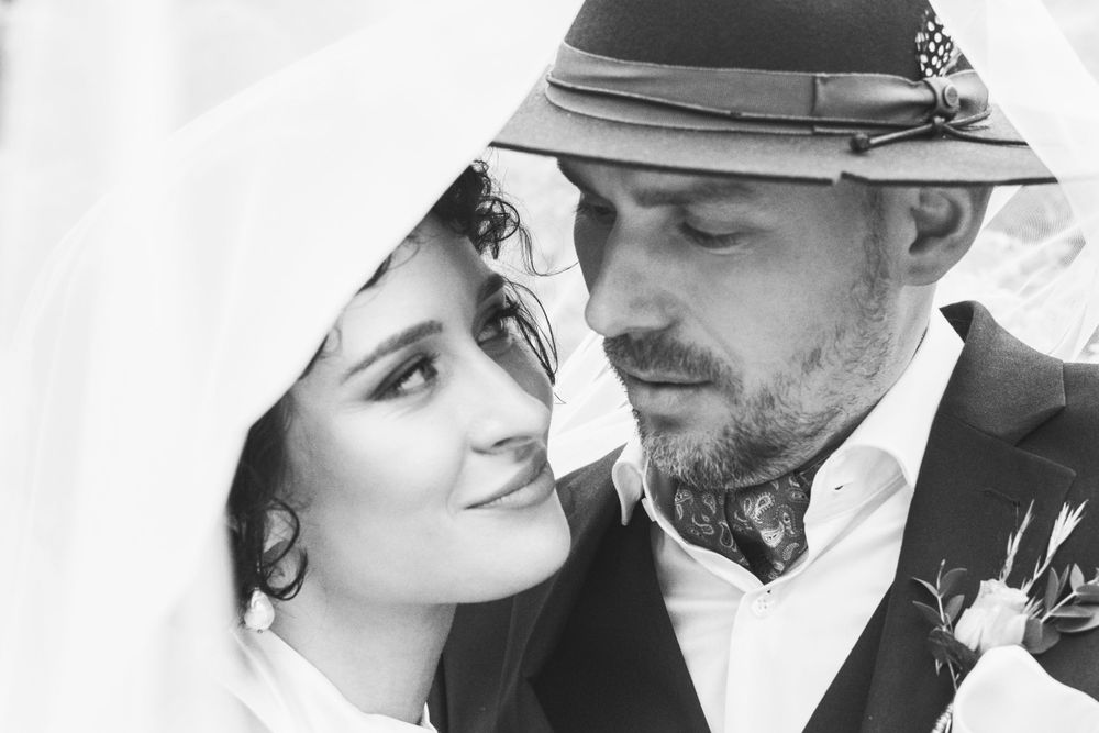 A bride and a groom looking at each other.