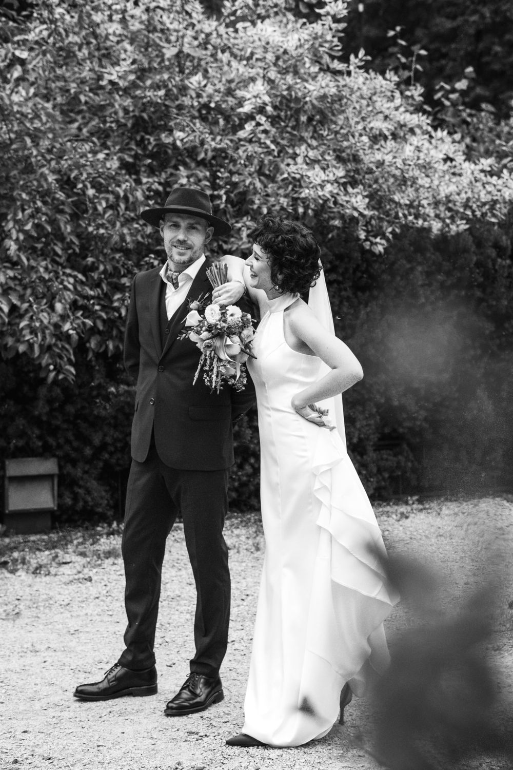 A bride and a groom in the park.