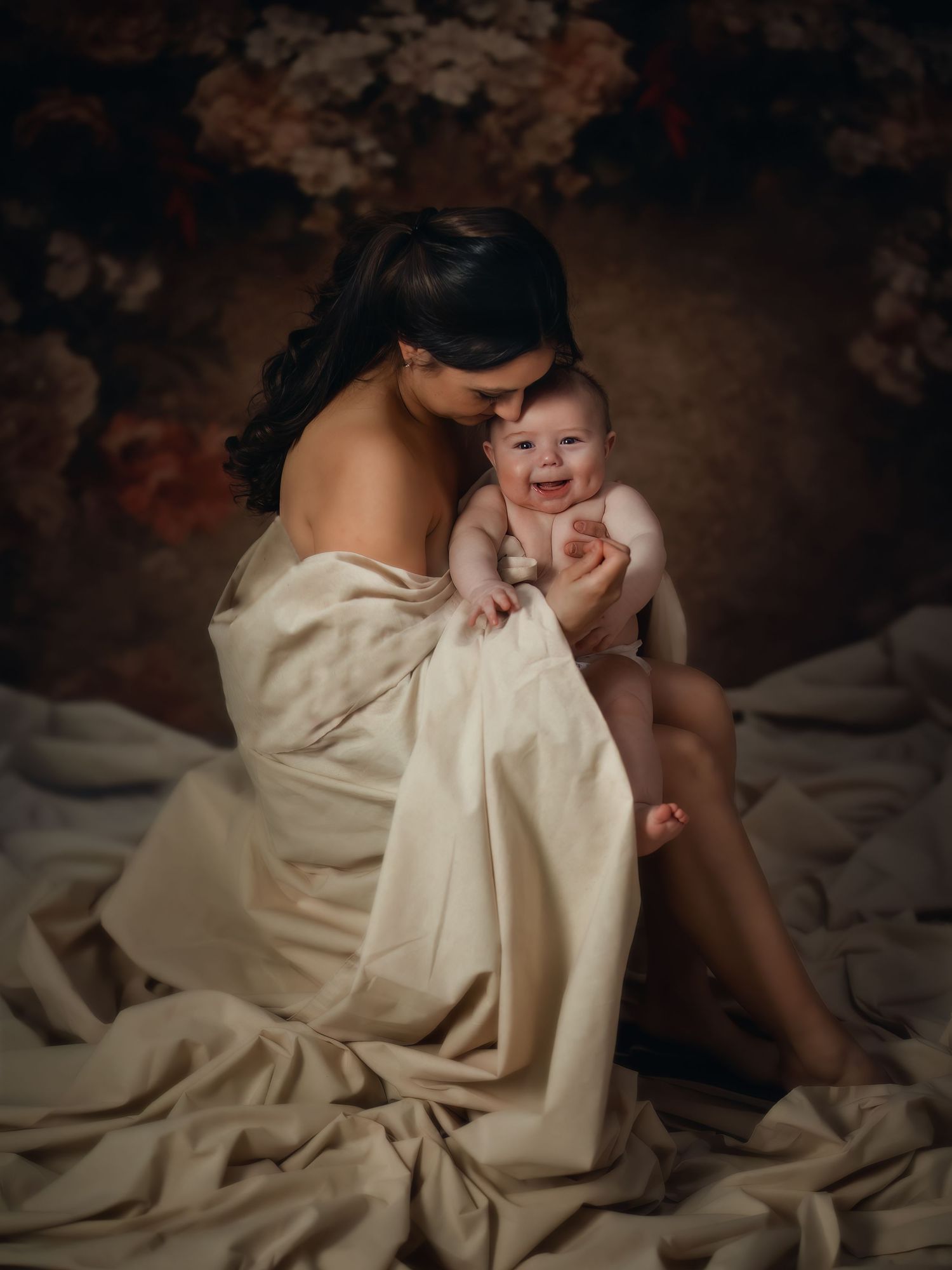 Elegant portrait of a mother and child in a timeless, floral-themed studio setup. Toronto motherhood photography.