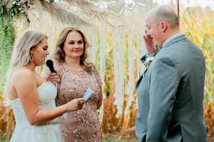 Emotional wedding ceremony moment captured during outdoor garden service.