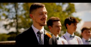 Groom Smiles Bride Walks Down the Isle Reaction Shot