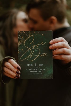 A dark green save the date card with gold lettering for June 1 2024.