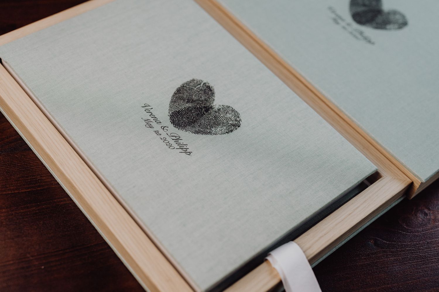 Photo album cover with heart design on white textured material.