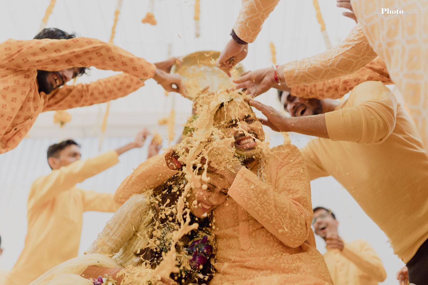 Traditional wedding cake smashing moment captured in a series of candid photos.
