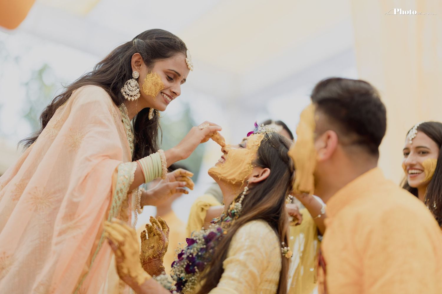 Guests in traditional attire share joyful moments during an Indian wedding celebration.