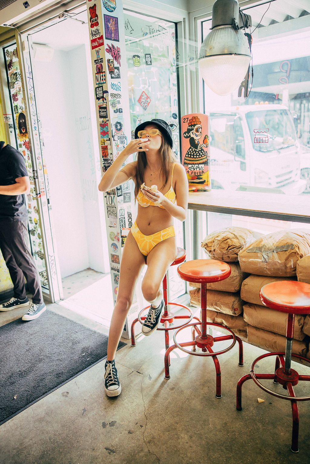 A casual scene inside a small shop with red stools and vintage decor.