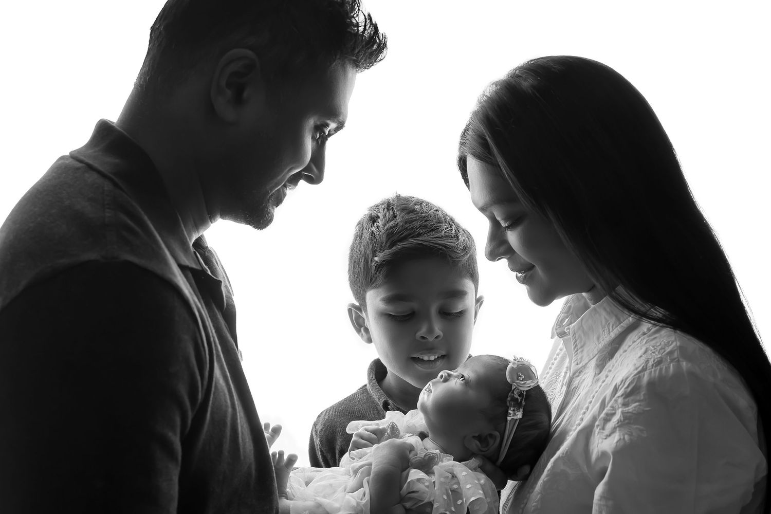 Emotive black and white silhouette of a father lifting his baby, celebrating joy and connection.