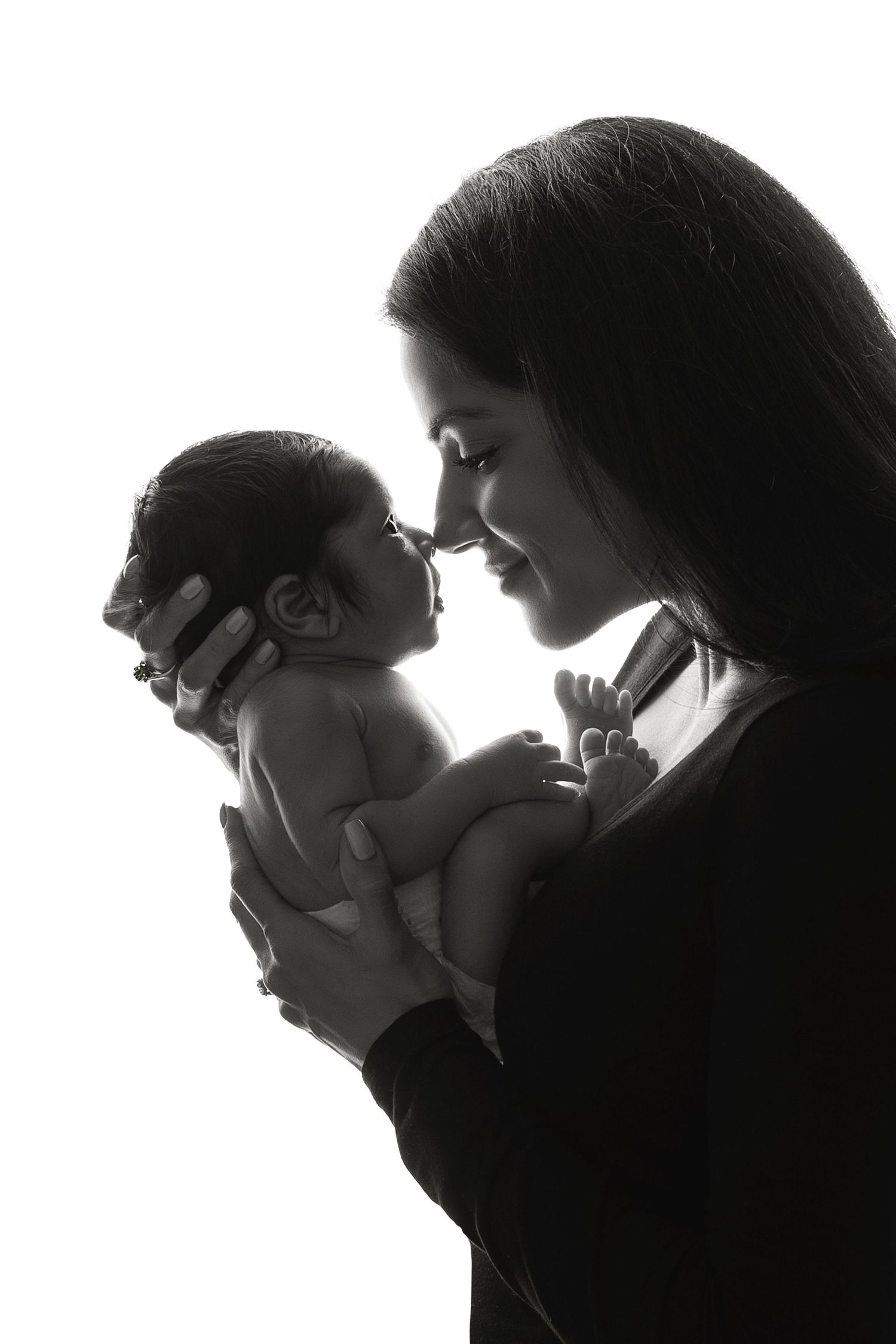 Stunning black and white silhouette of a mother and baby, capturing an intimate, unforgettable moment.