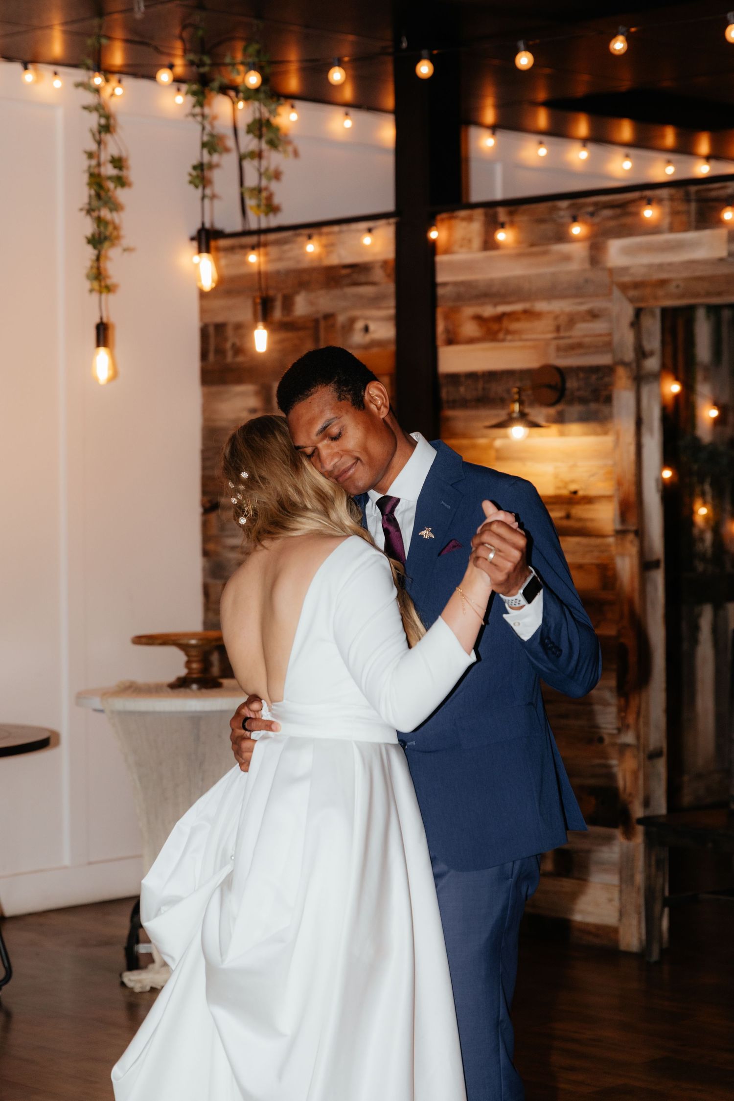Groom cuddling in love with bride during first dance