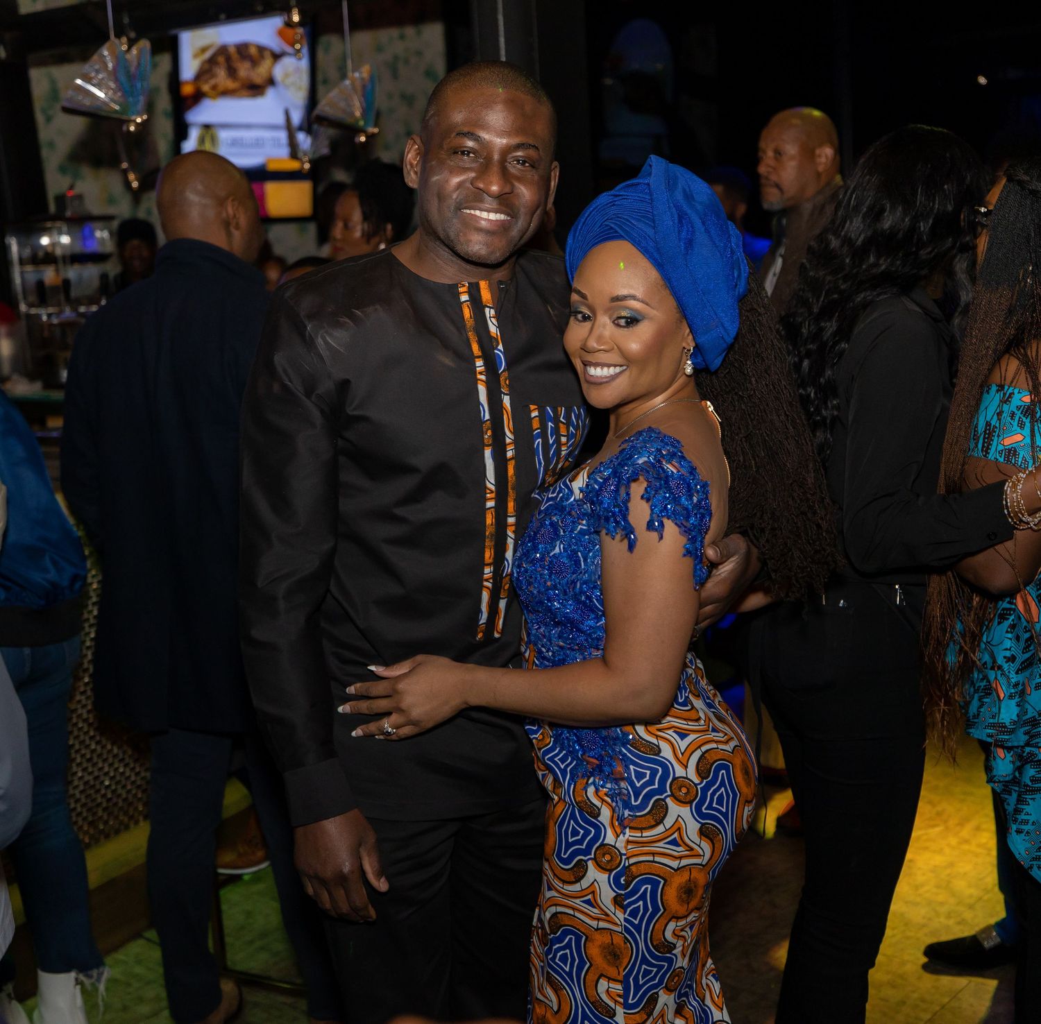 Couple in traditional African attire at formal evening event.