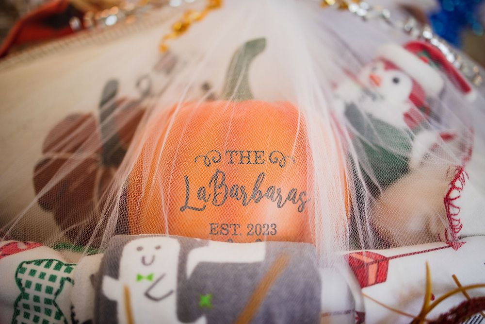 Close-up detail of orange pumpkin with text in stylized lettering.