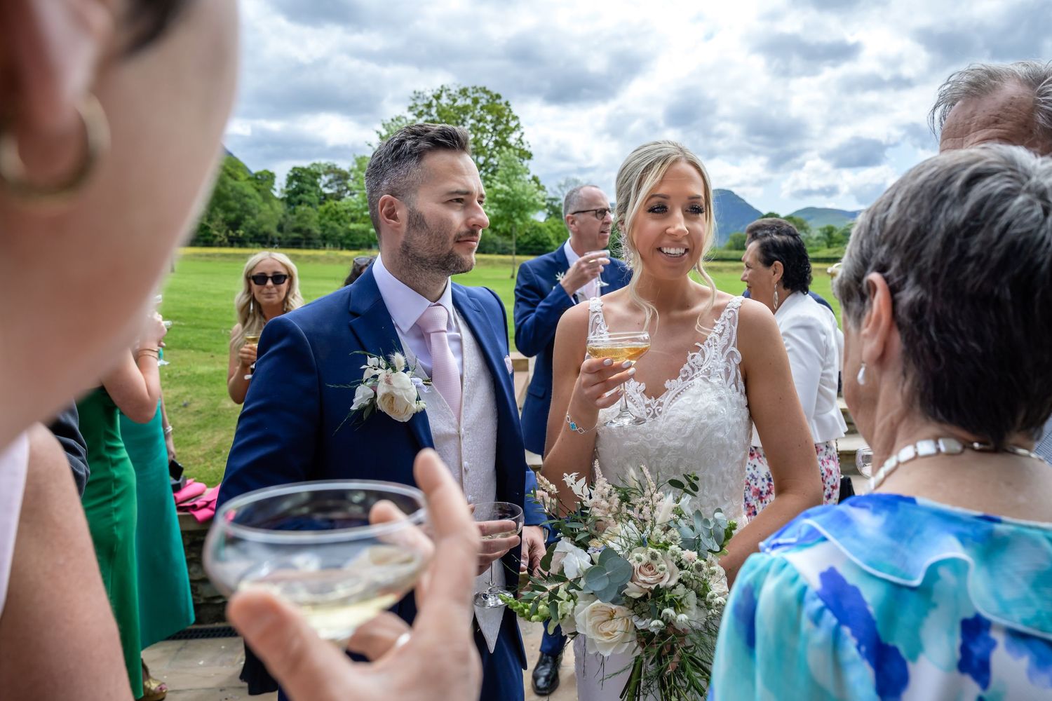Bride and groom with guests during reception drinks at New House Farm wedding