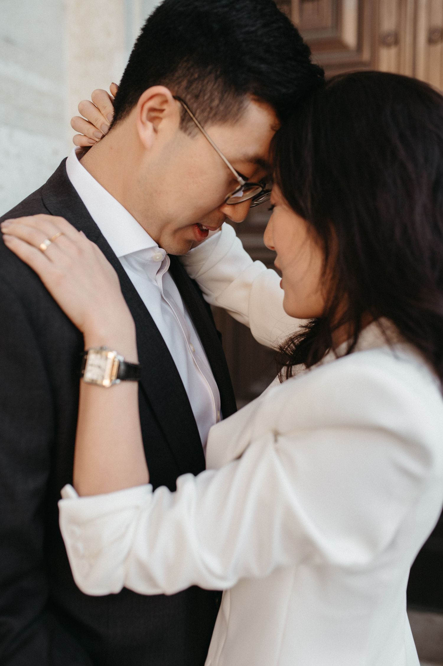 Intimate close-up portrait of a couple in white and black formal wear.