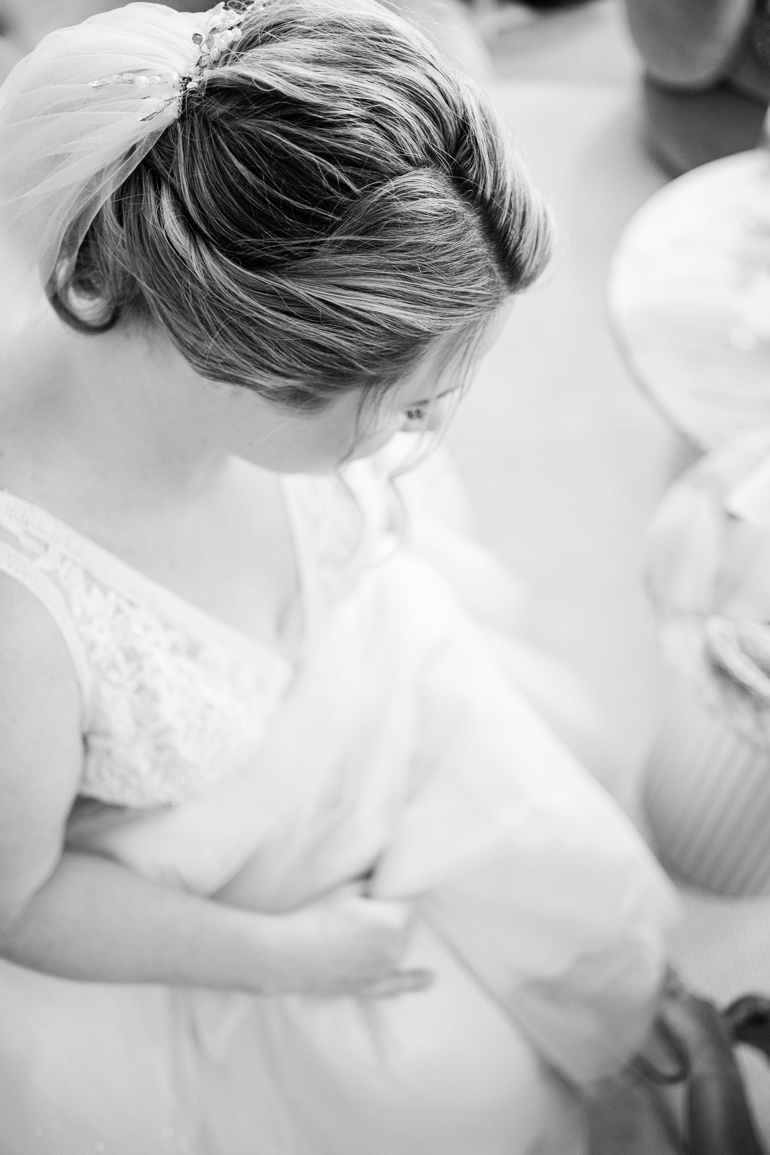 An intimate black and white portrait capturing a quiet wedding day moment.
