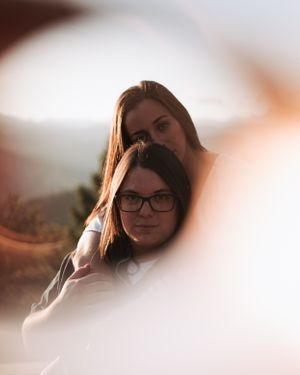 A couple leans on each other for their engagement photo