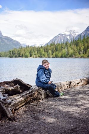 Grant relaxing with McDonald Lake and Glacier mountains behind him in Glacier National Park!