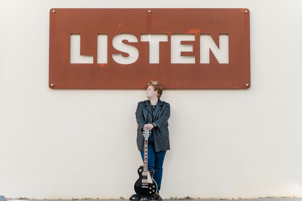 senior session girl holding electric guitar downtown winter haven, florida