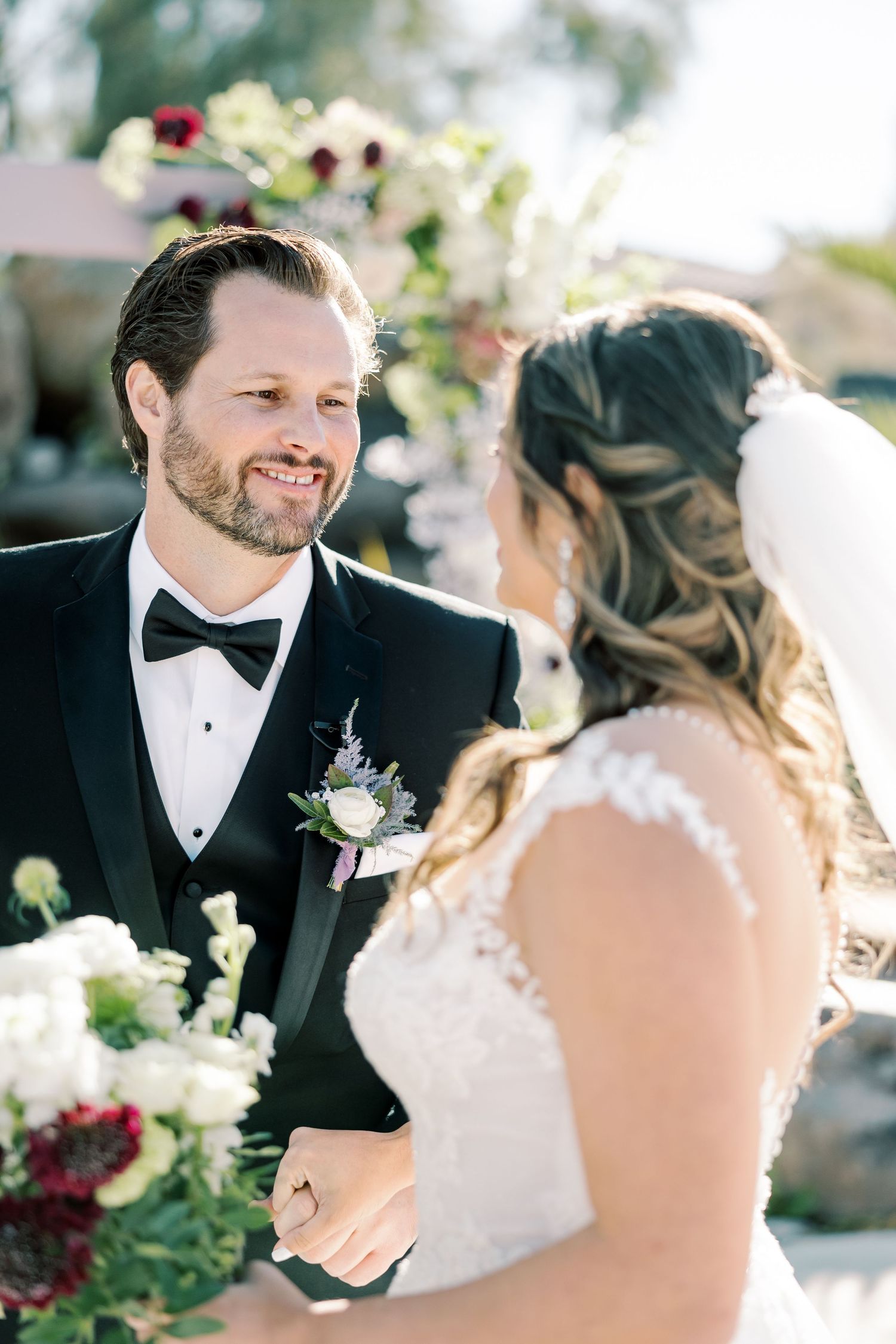 A romantic wedding moment captured in a sunlit garden setting.