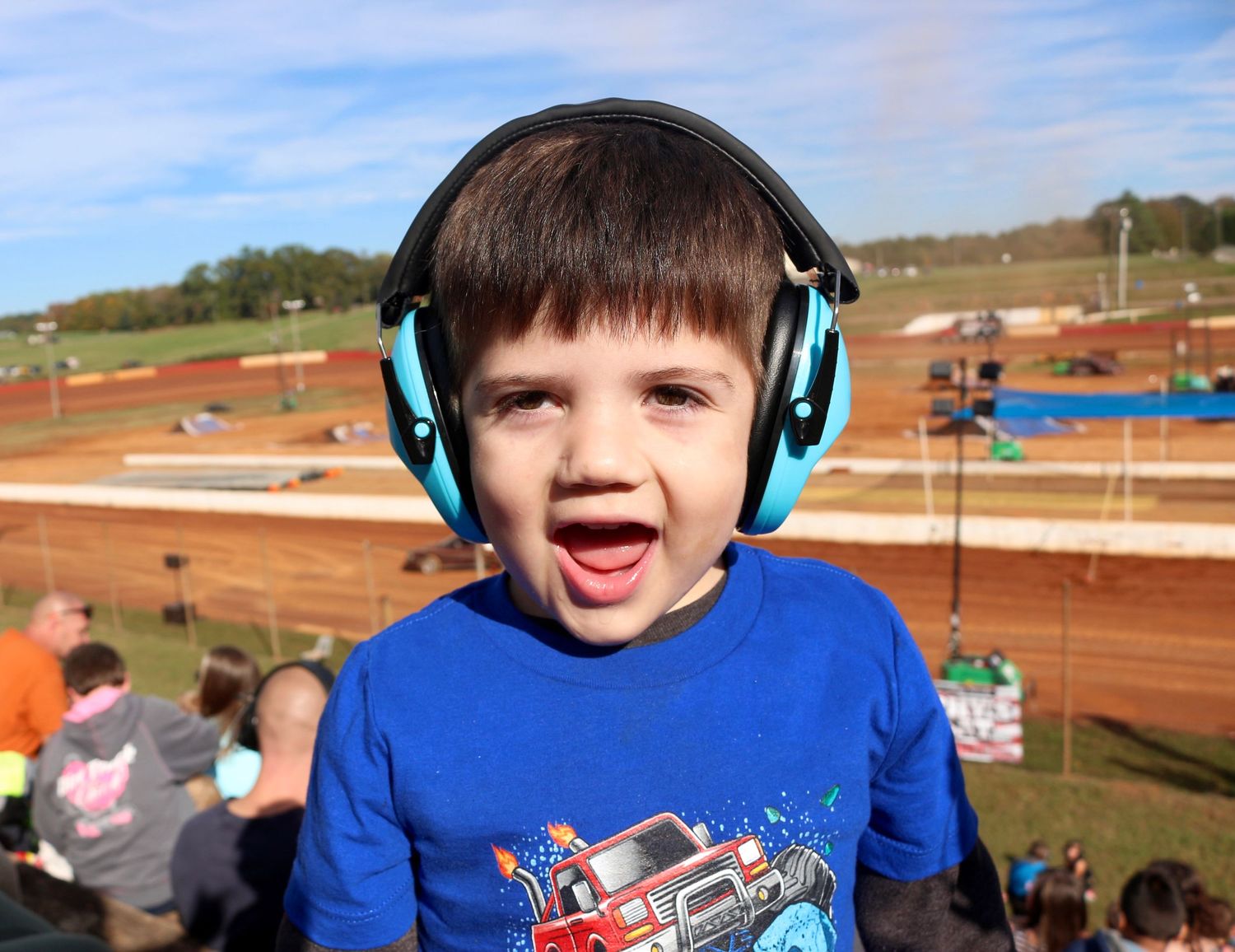 boy in blue shirt at monster truckz show