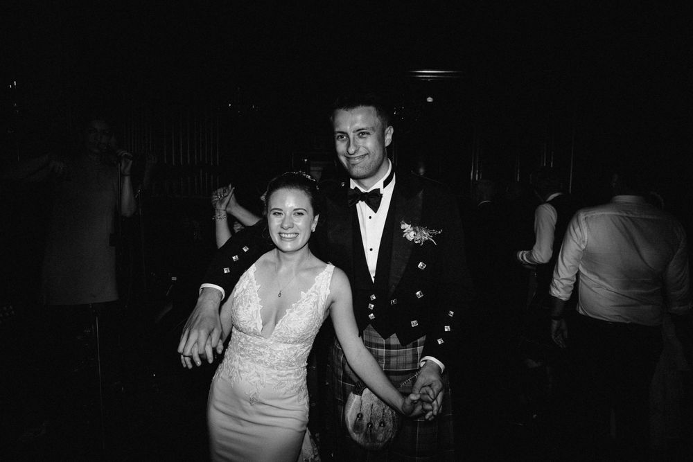 Black and white photo of guests dancing at an elegant evening reception.