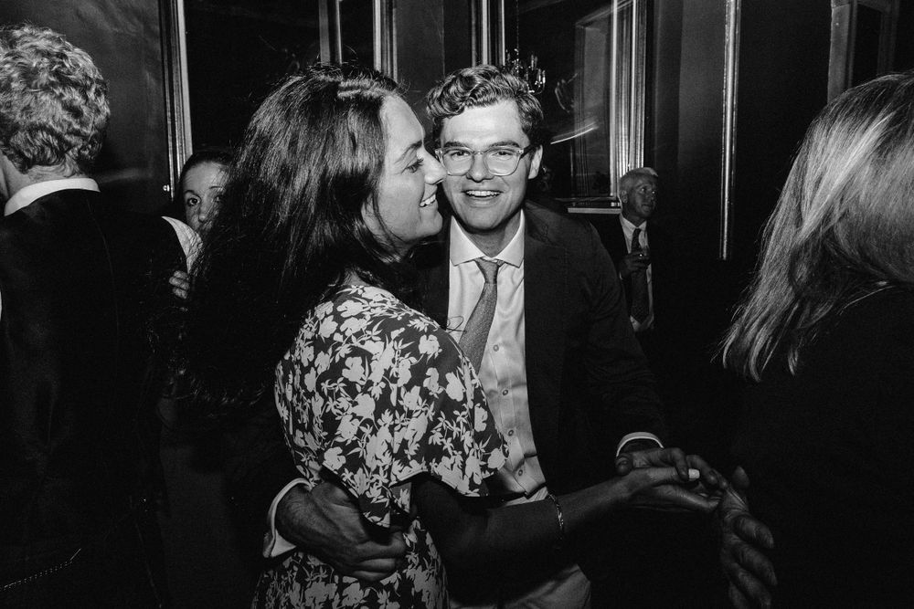 Black and white candid shots of guests enjoying themselves at an evening celebration.