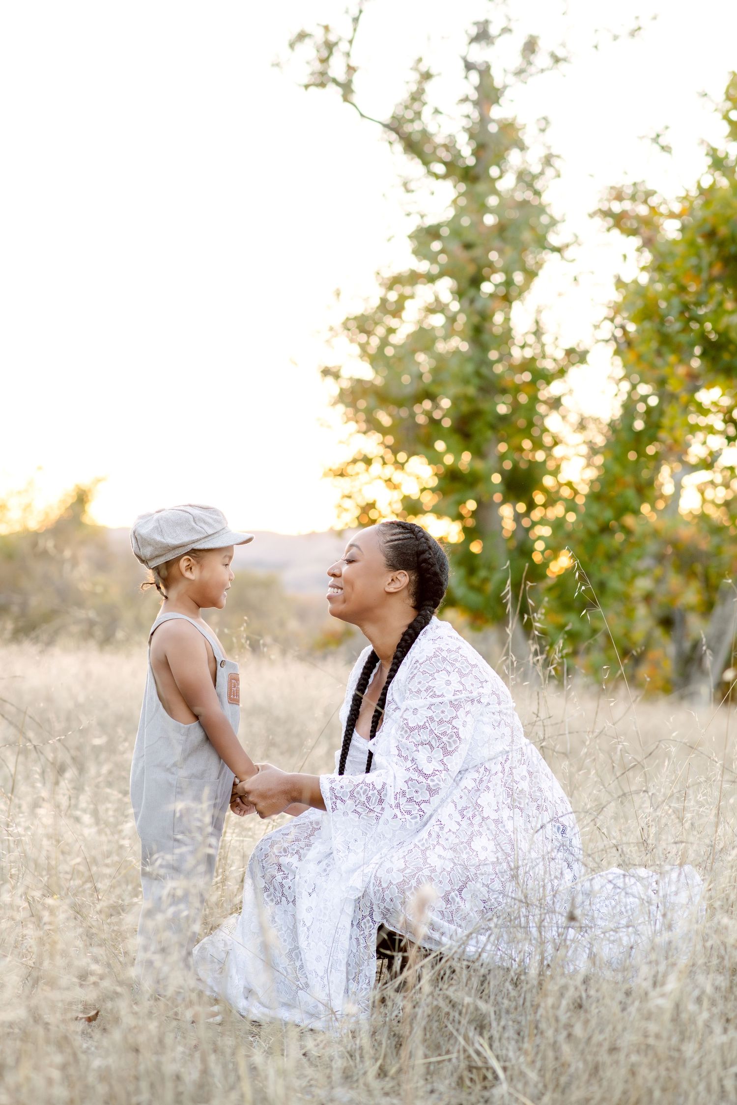 An intimate conversation moment captured in a sun-drenched field with natural golden lighting.
