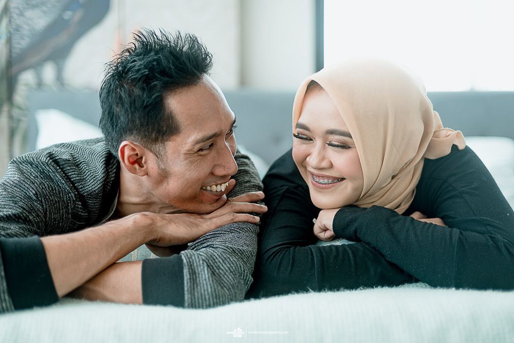 A couple shares an intimate moment while relaxing together.